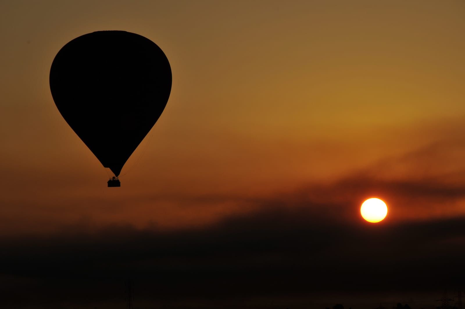 Hot-air balloon silhouetted against the sunrise over Luxor’s West Bank.