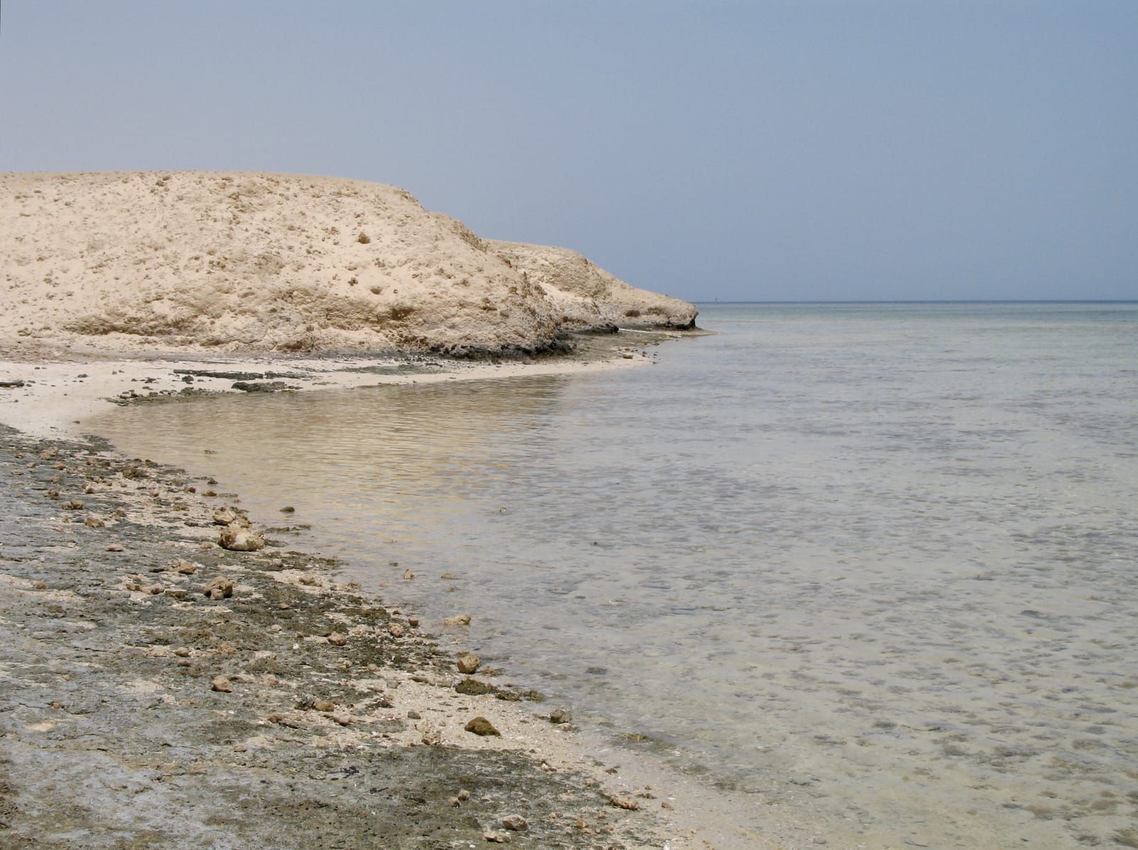 Rocky desert shoreline meeting the Red Sea near Port Ghalib in the Marsa Alam area.